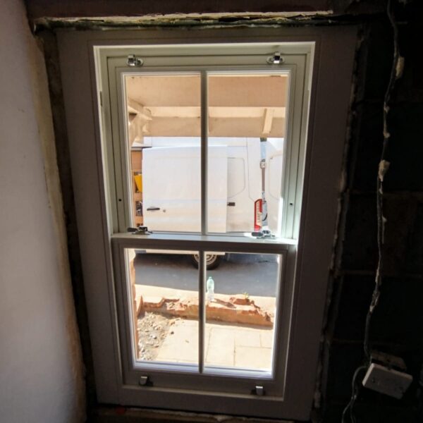 Timber sash window being fitted, Pirbright, Surrey