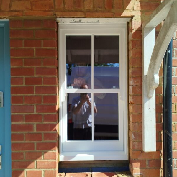 Timber sash window in a brick porch, Pirbright, Surrey